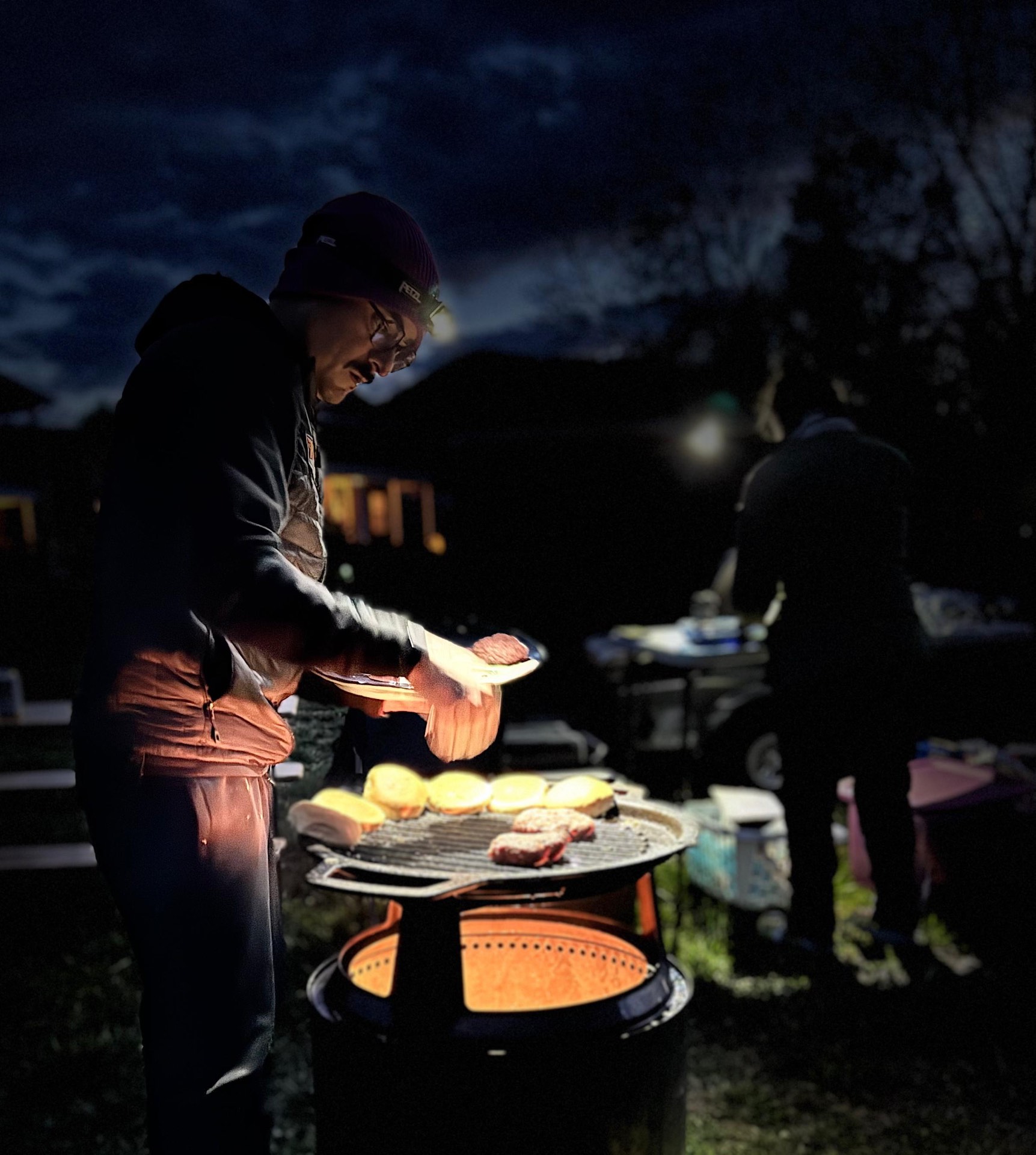 Anthony cooking dinner over the campfire